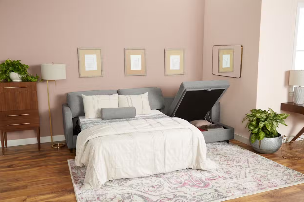 a grey joybird briar sleeper storage sectional in a home with the bed set up and the storage chaise open, good housekeeping's best sleeper sofas