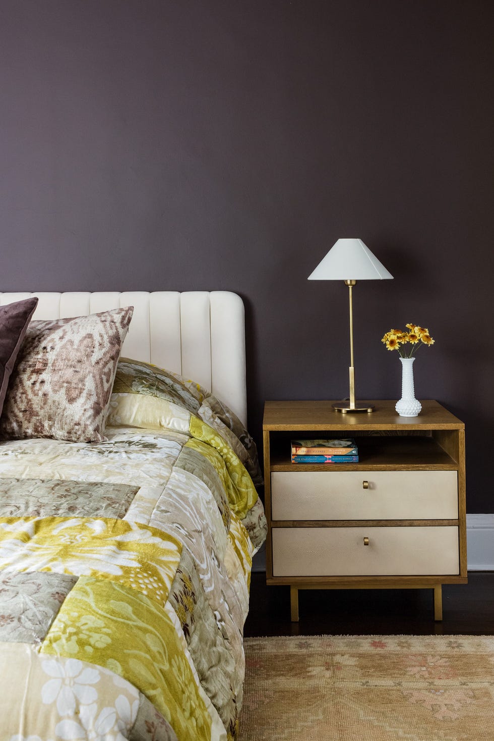 A cozy bedroom setup featuring a bed nightstand lamp and decorative elements a cozy bedroom setup featuring a bed nightstand lamp and decorative elements