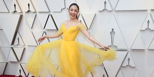 Dress, Yellow, Shoulder, Red carpet, Carpet, Clothing, Flooring, Gown, Beauty, Fashion, 