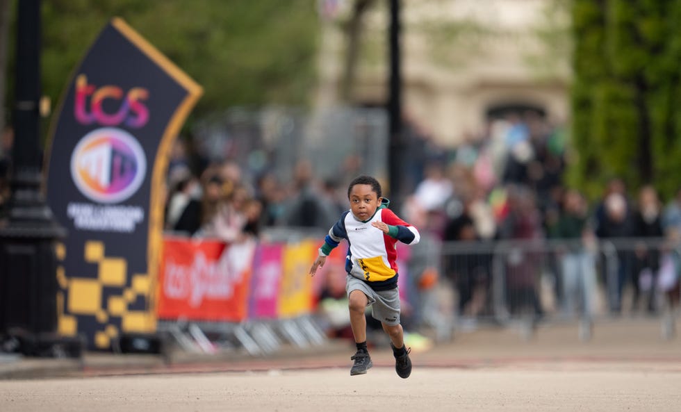 a small child running fast along a road in london