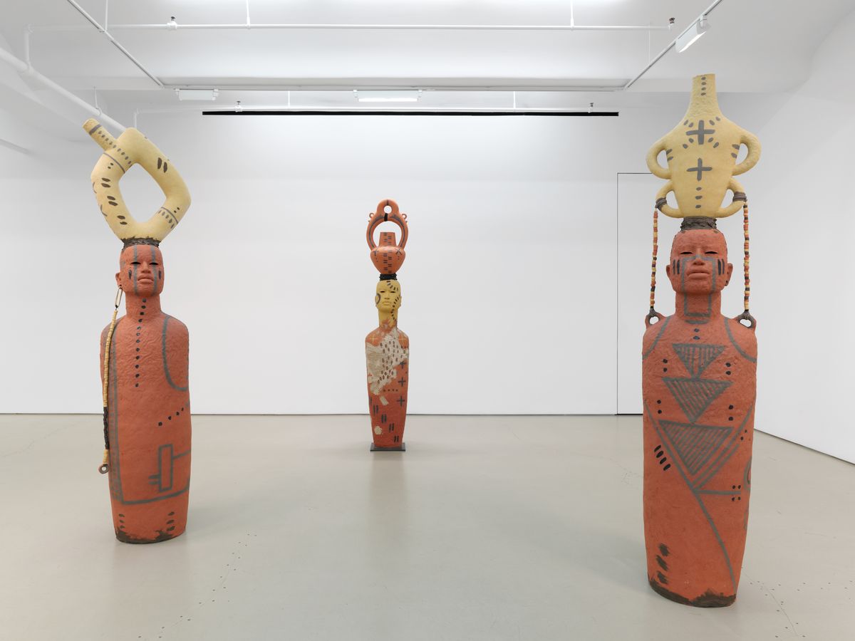 installation view of three sculptural beings