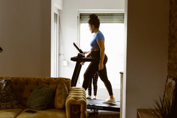 a person walking on a treadmill in a cozy living room