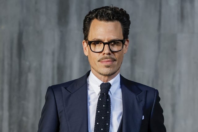a man in a formal suit with a blurred face