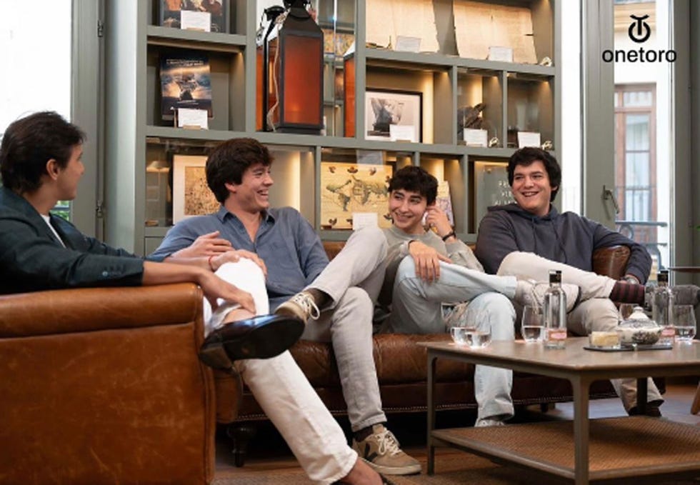 a group of men sitting on a couch