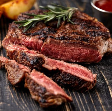 Juicy steak medium rare beef with spices on wooden board on table Juicy steak medium rare beef with spices on wooden board on table