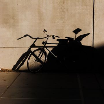 a bicycle parked against a wall