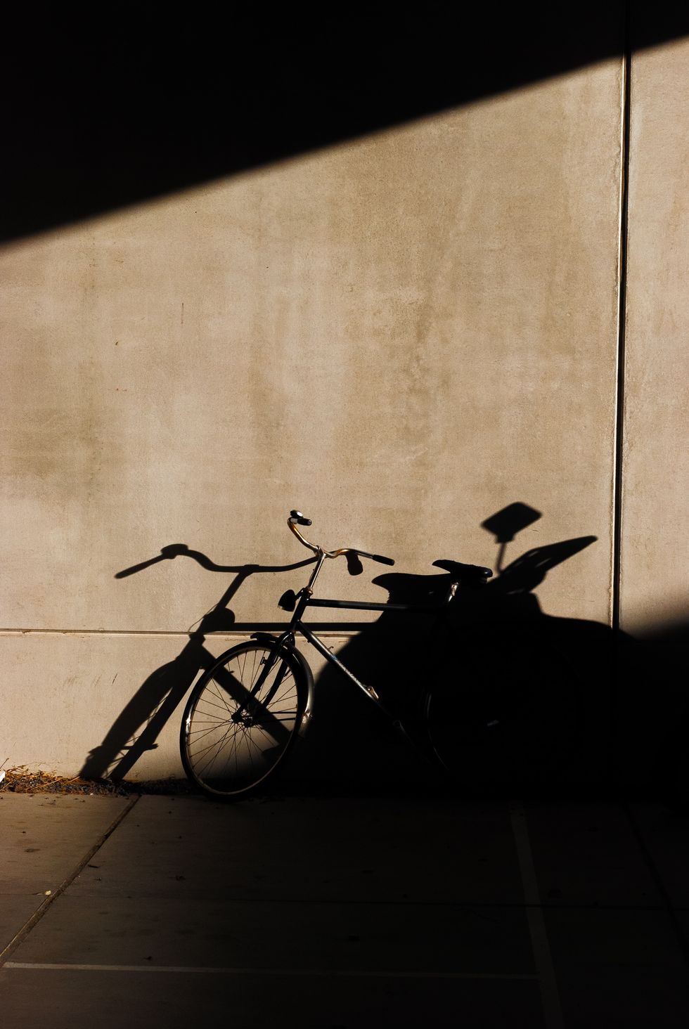 a bicycle parked against a wall