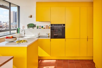 modern streamlined kitchen in bright yellow with london skyline views