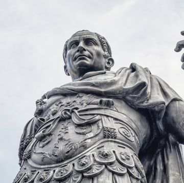 statue of a man wearing armor as he makes an assertive gesture