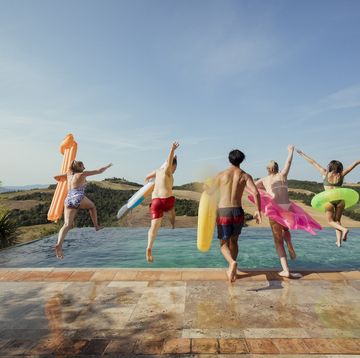 friends jumping in the pool