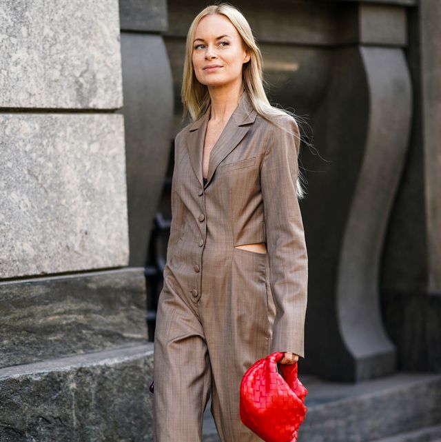 milan, italy   february 22 thora valdimars wears earrings, a brown full length wide legs jumpsuit with a slot at the waist, green nacreous pointy pumps, a red woven leather handbag , outside philosophy, during milan fashion week fallwinter 2020 2021 on february 22, 2020 in milan, italy photo by edward berthelotgetty images