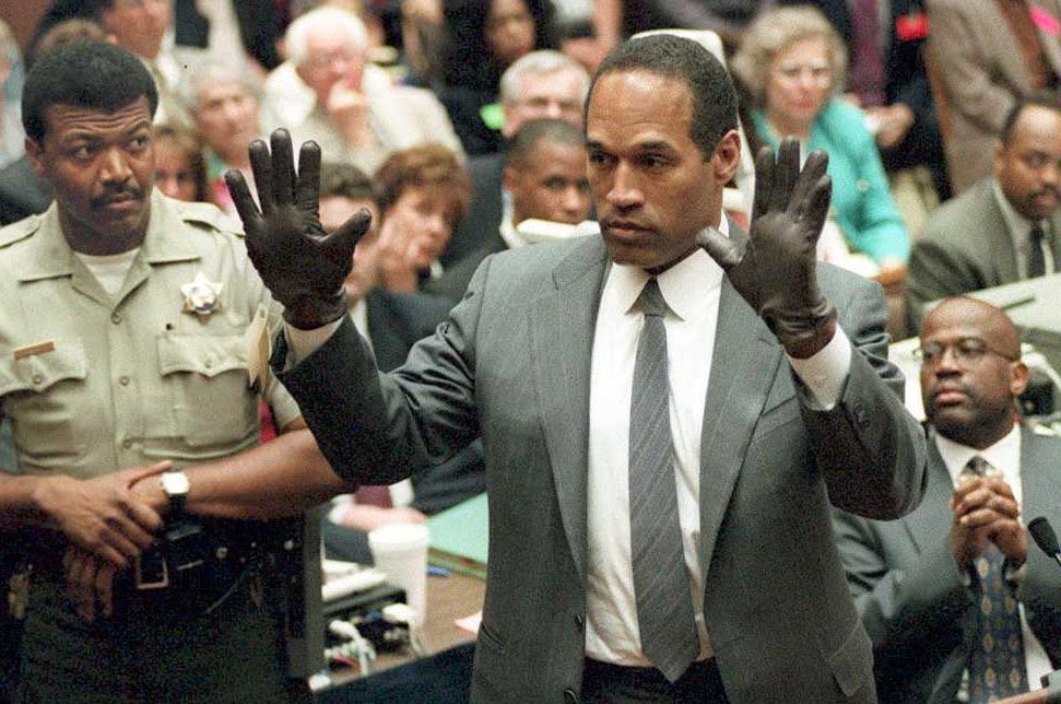 O.J. Simpson trying on gloves during his murder trial