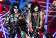 gene simmons and paul stanley of kiss playing guitars at a convert