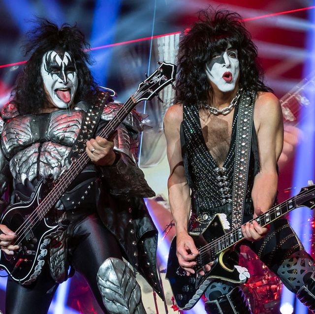 gene simmons and paul stanley of kiss playing guitars at a convert