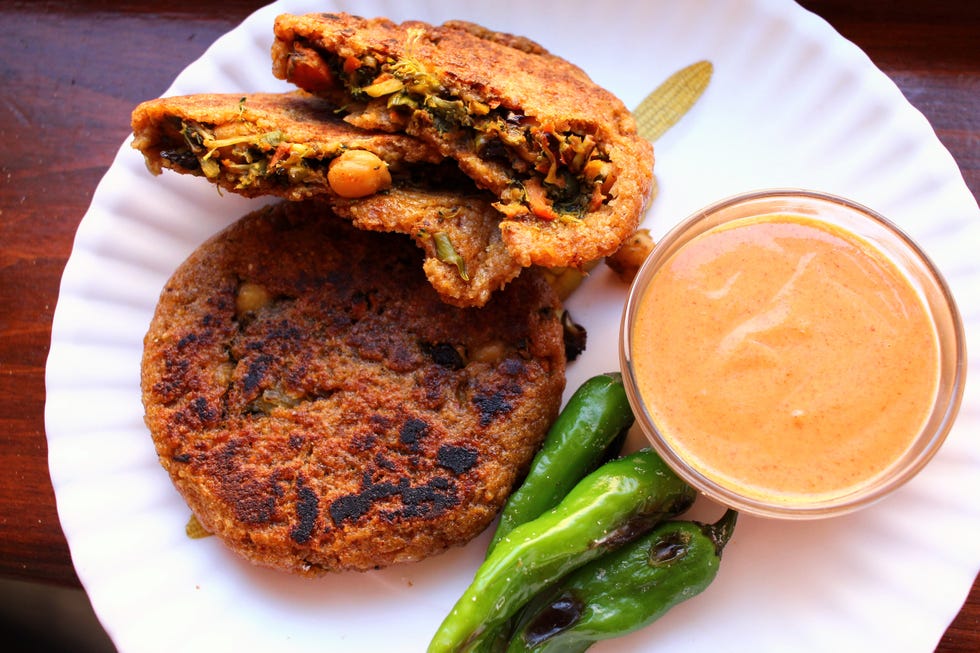 a roasted veggie medley of broccoli, cauliflower, and chickpeas stuffed into a seared brown rice patty, served alongside a spicy peanut sauce