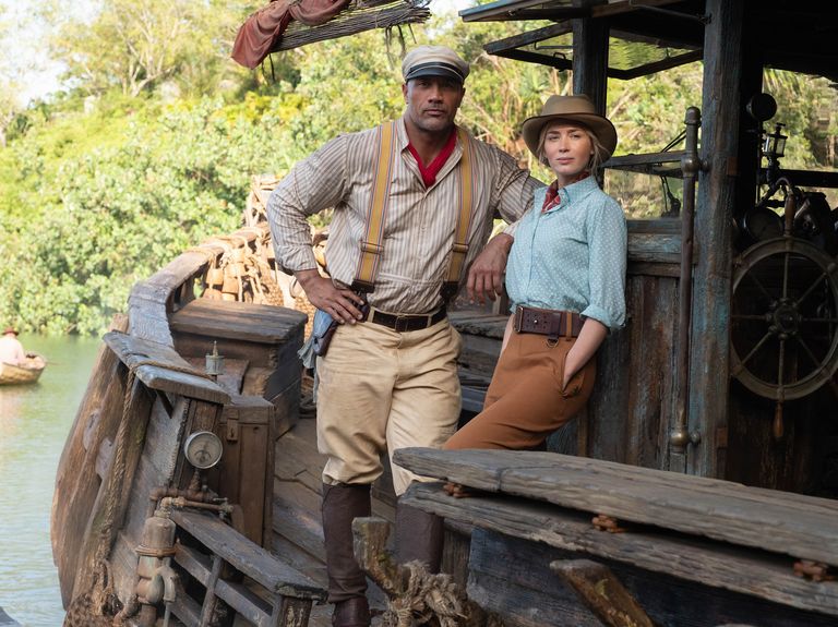 dwayne johnson and emily blunt standing on a boat in the disney movie jungle cruise