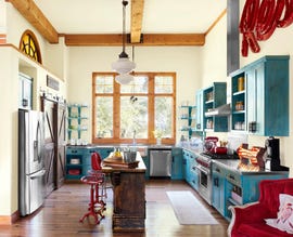 rustic kitchen with light yellow walls and blue cabinetry