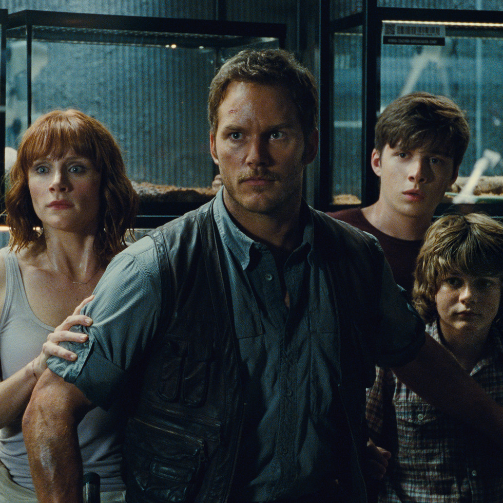owen brady protects claire dearing and her nephews in a scene from 'jurassic world,' the fourth movie if you want to watch the jurassic park movies in order