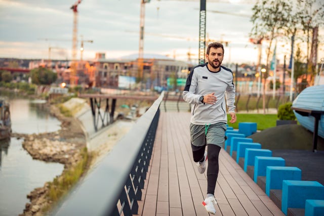just keep running young sportsman is running and jogging on the bridge in the dusk health activities