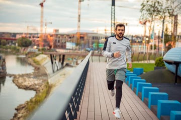 just keep running young sportsman is running and jogging on the bridge in the dusk health activities