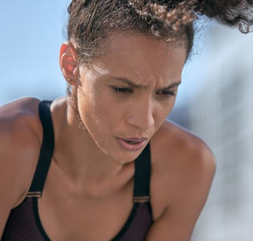 woman in sports bra breathing heavily