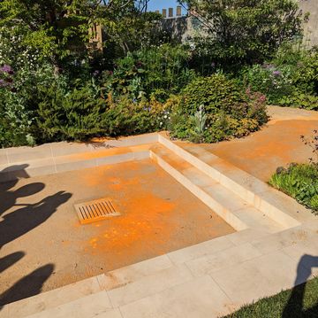 just stop oil target chelsea flower show garden with orange paint