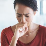 what is croup, woman coughing holding tissue