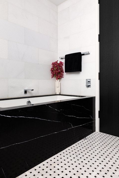 black marble bathtub, white and black square tiles