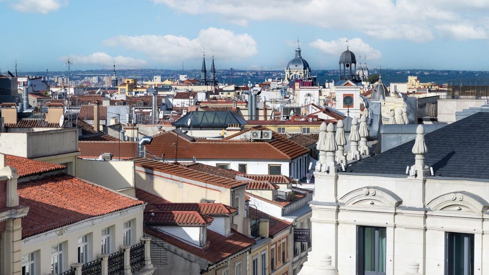 view of a city skyline featuring various rooftops and architectural details
