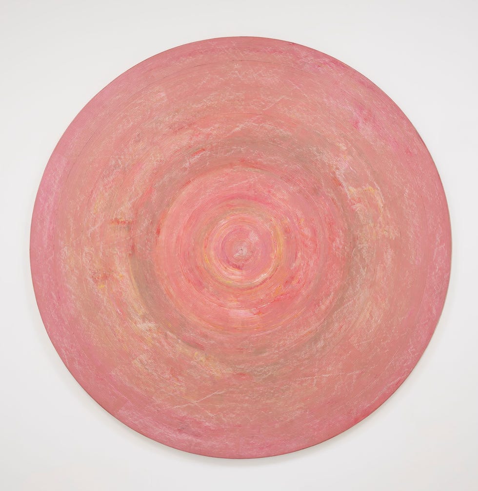 circular abstract artwork featuring concentric patterns in soft pink hues
