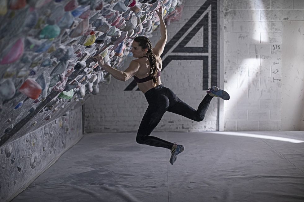 kyra condie bouldering on a climbing wall