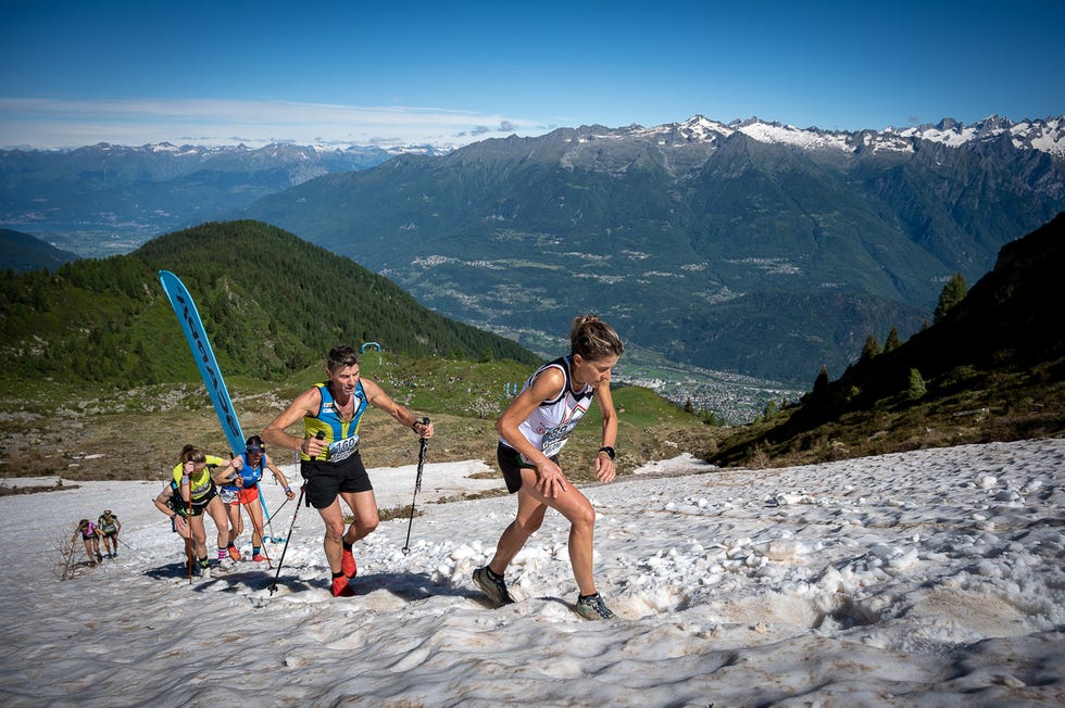 athletes participating in a mountain climbing race on snowcovered terrain