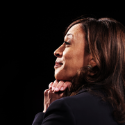 kamala harris at the vice presidential debate smiling in profile view with her hands under her chin
