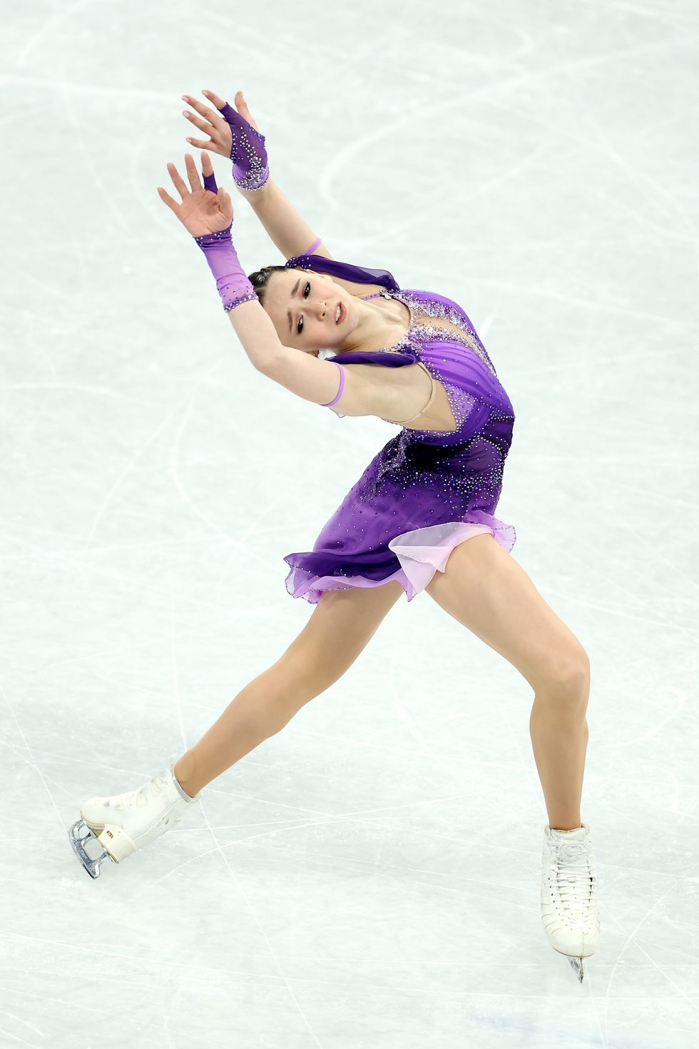 kamila valieva competing at the 2022 beijing winter olympics in a purple dress