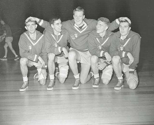 man embracing teammates