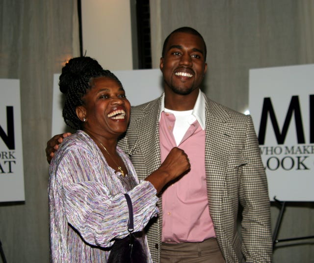 donda west and kanye west smile and embrace while posing for photos