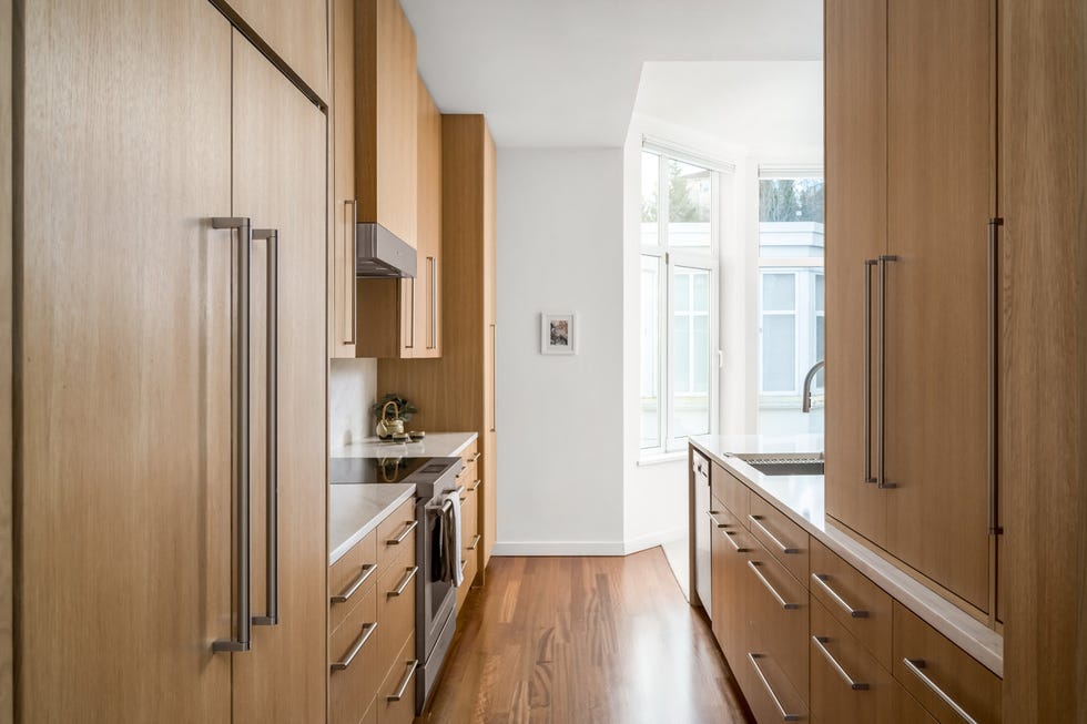 modern kitchen with wooden cabinetry and stainless steel appliances