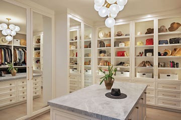 a white kitchen with a table and shelves