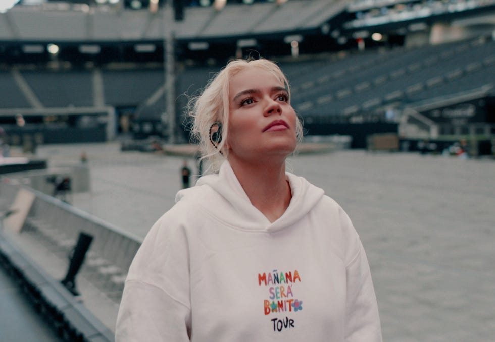 person wearing a hoodie in a concert venue