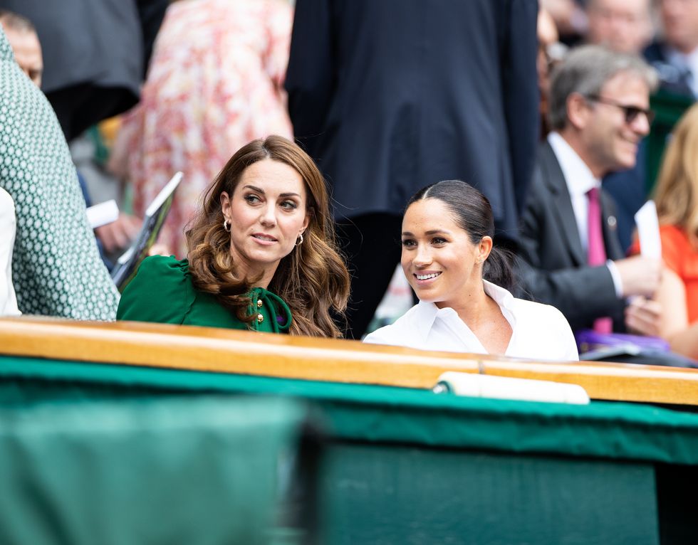 london, england july 13 catherine, duchess of cambridge talks with meghan, duchess of sussex in the royal box before the start of the womens singles final between simona halep of romania and serena williams of usa at the wimbledon lawn tennis championship at the all england lawn and tennis club at wimbledon on july 13, 2019 in london, england photo by simon brutyanychancegetty images