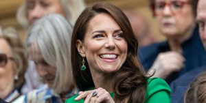 catherine, princess of wales, in the royal box during the gentlemens singles final match at wimbledon smiling wearing a green dress and green earrings