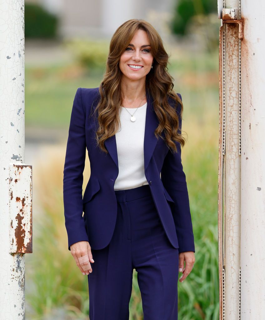 kate middleton wearing a navy suit at hmp high down surrey