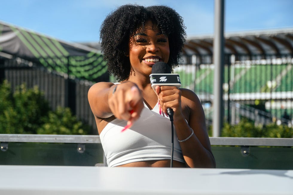 katelyn hutchison holding microphone and pointing to camera