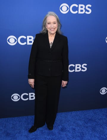 kathy bates smiles on the blue carpet