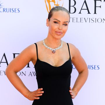 katie piper at 2024 bafta television awards, wearing a black dress and a silver necklace