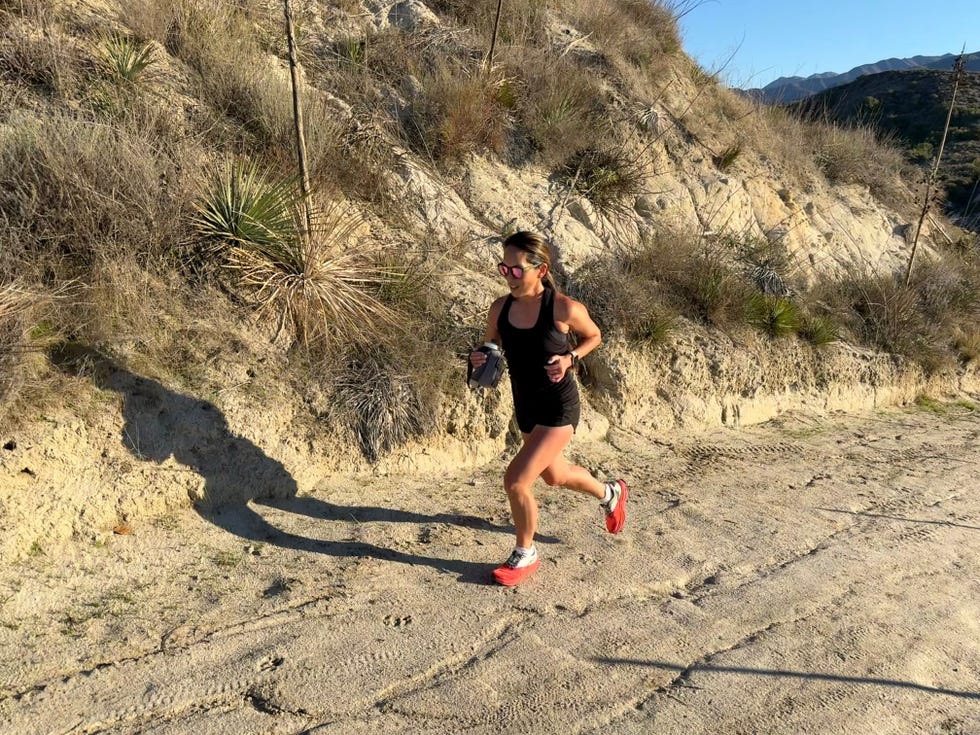 woman running in sand dunes