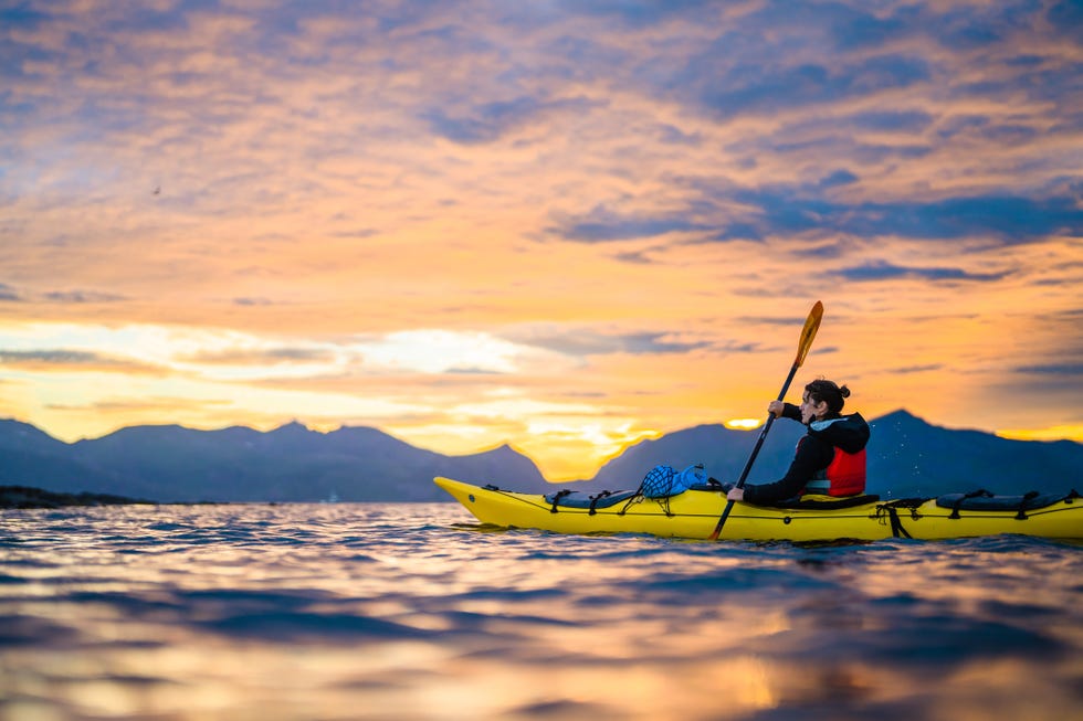 kayaking under the midnight sun in lofoten islands, norway