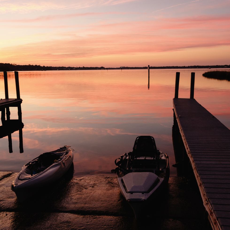 kayaks near dock at sunset