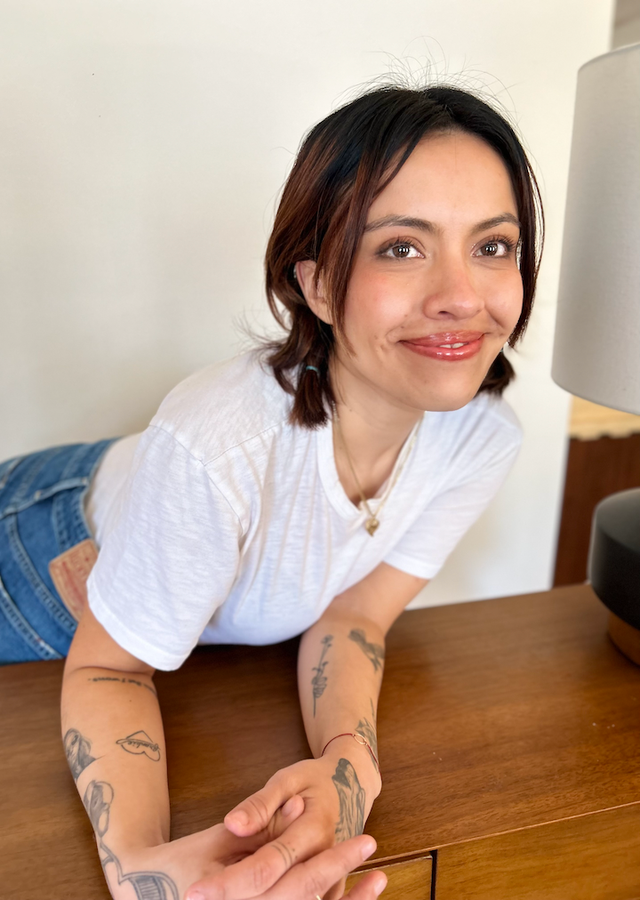 karla cornejo villavicencio leaning against a table