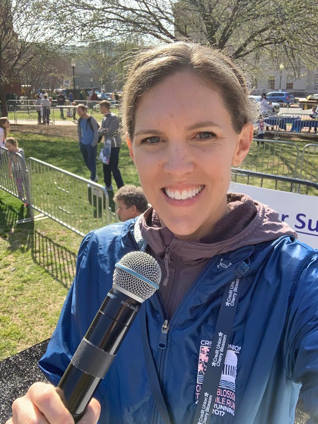 a woman taking a selfie while holding a microphone